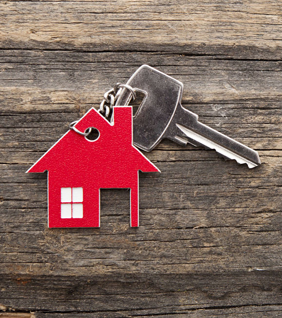 Real estate lawyer Mayra Prado-Pagan - house key with red house keychain.